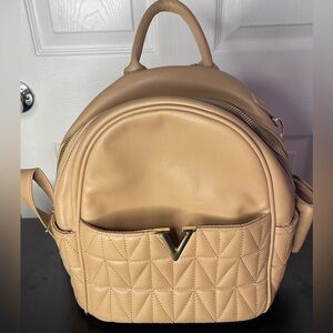 Tan woman’s backpack